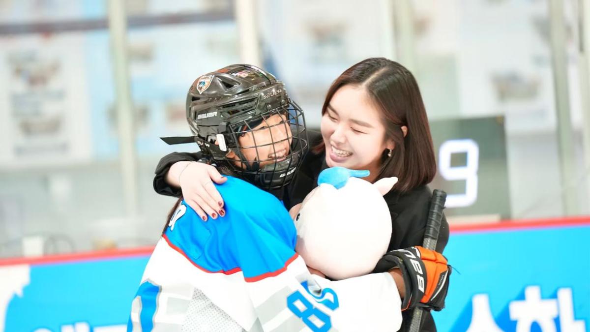 player and coach hugging