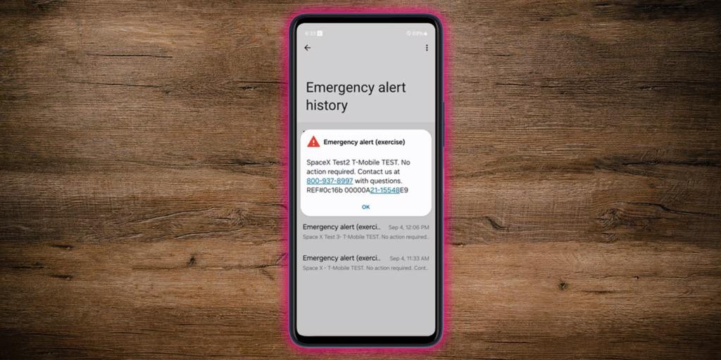 Phone on a wood table displaying an emergency message