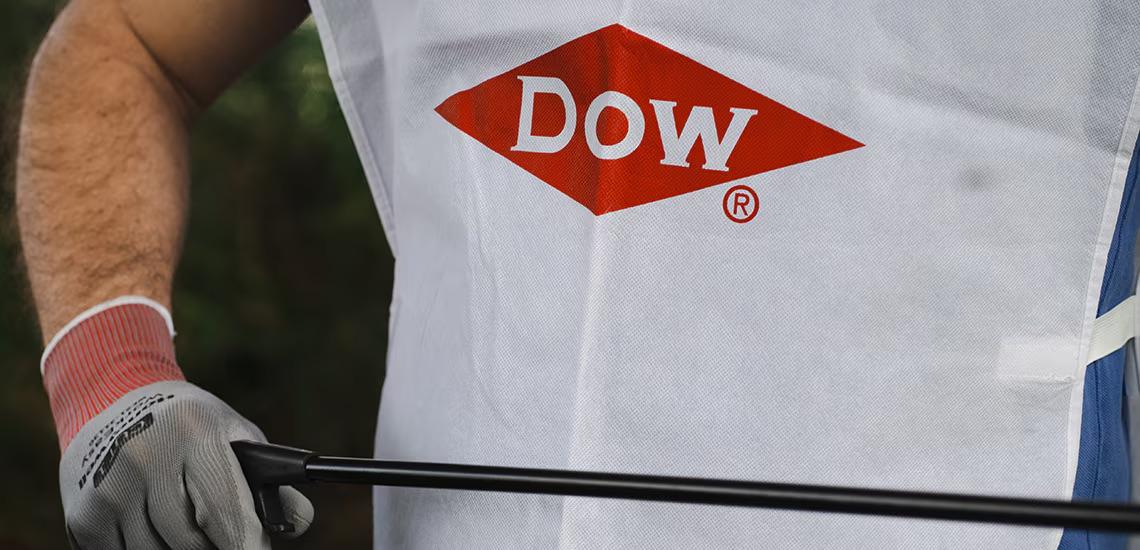 person wearing gloves and a Dow shirt