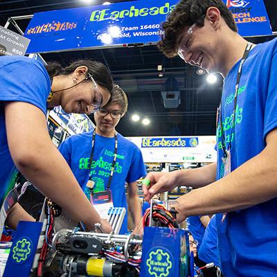FIRST, people working on a robot