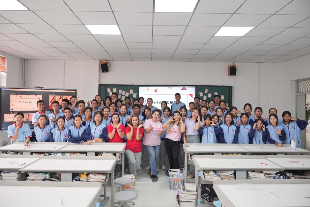 Group of students posed together in a classroom