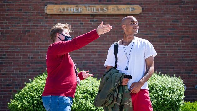 2 people in front of Father Bills Place