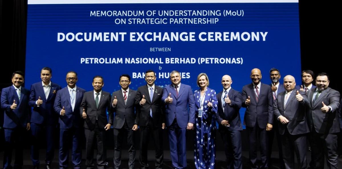 group photo at the Document Exchange Ceremony with participants giving the thumbs up sign