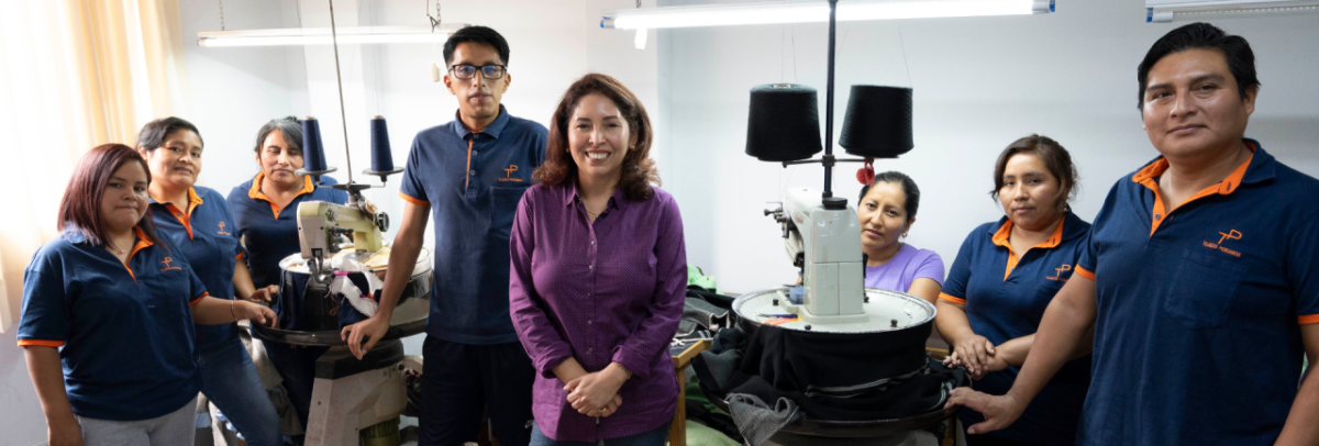 Violeta Pacheco Mejía, center, the owner of Tejidos Peruanos in Villa El Salvador, Peru, with some of her employees. (Photo credit: Carey Wagner/Peru) " "