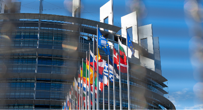 Photo of outside of a building with the flags of EU flying.