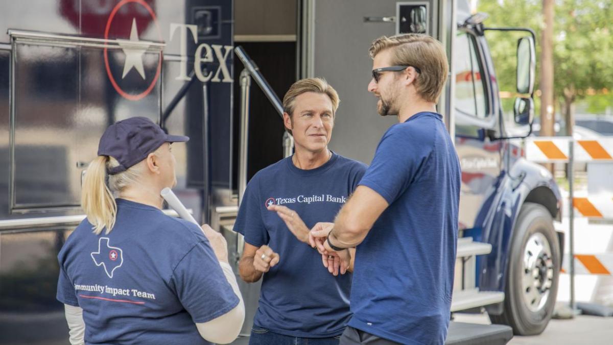 group at event all wearing Texas Capital Bank Tshirts