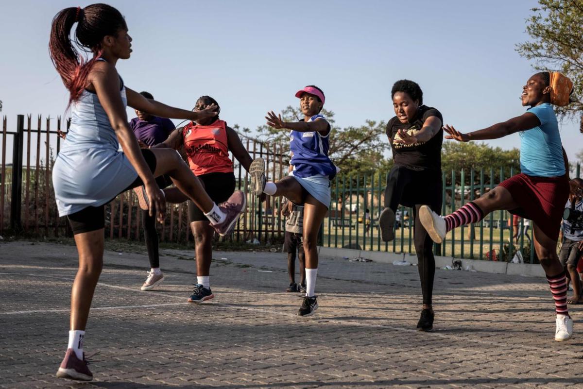 A group of people doing exercises outside.