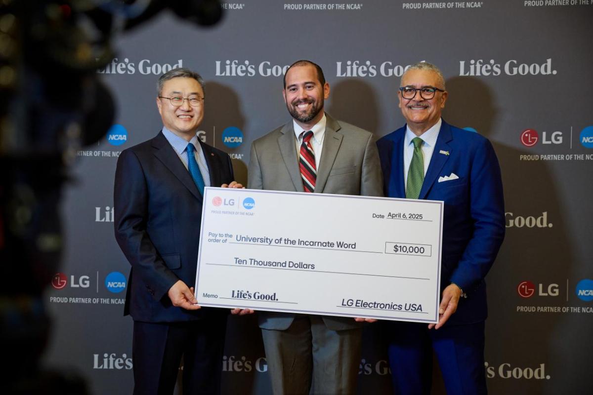 Three people posing with an oversized check
