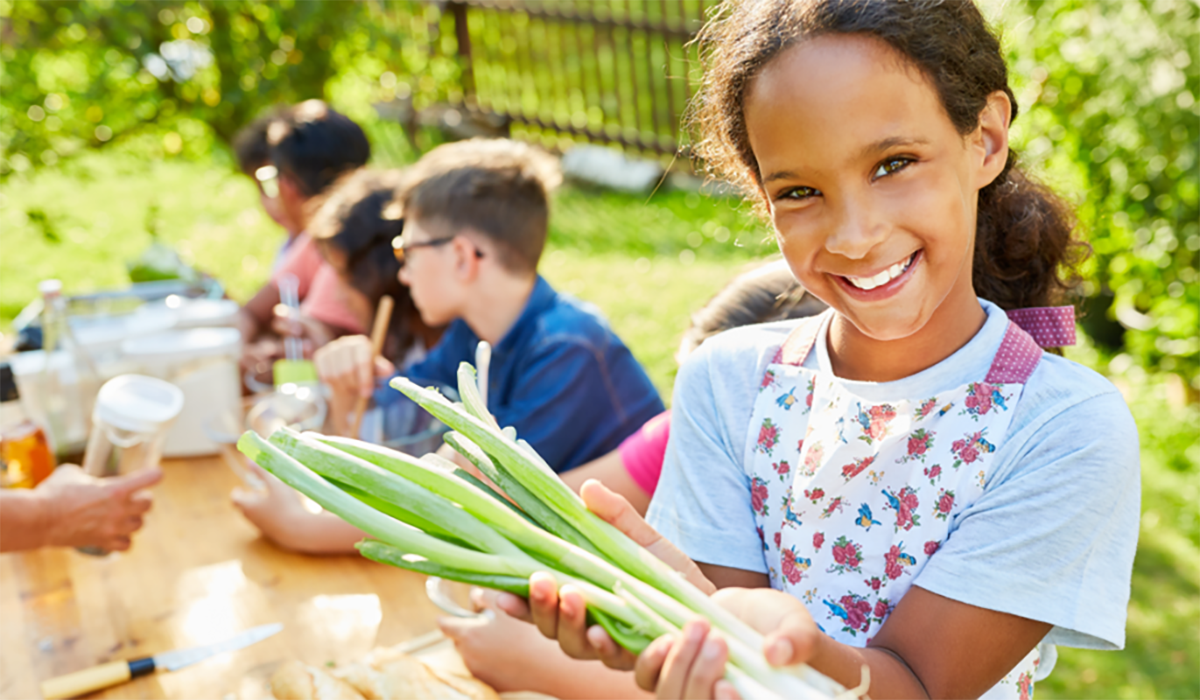 young person with veggies