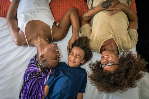 Image from #StyleWithPride Gallery (Photo: Business Wire) Family laying in bed