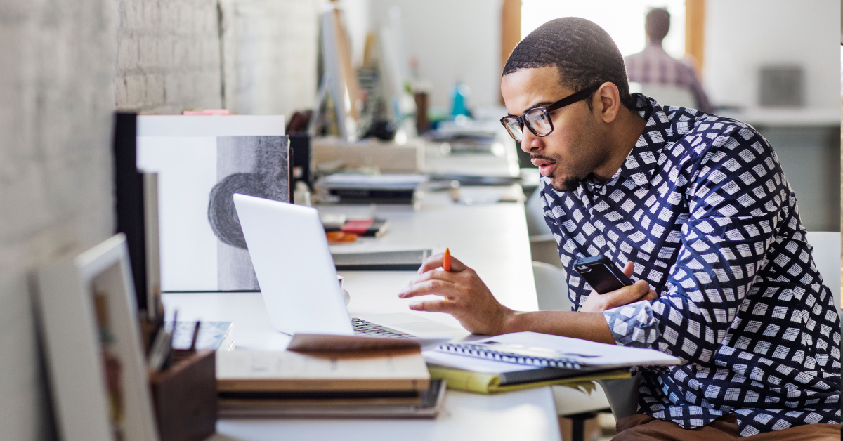 A person at a desk using a laptop