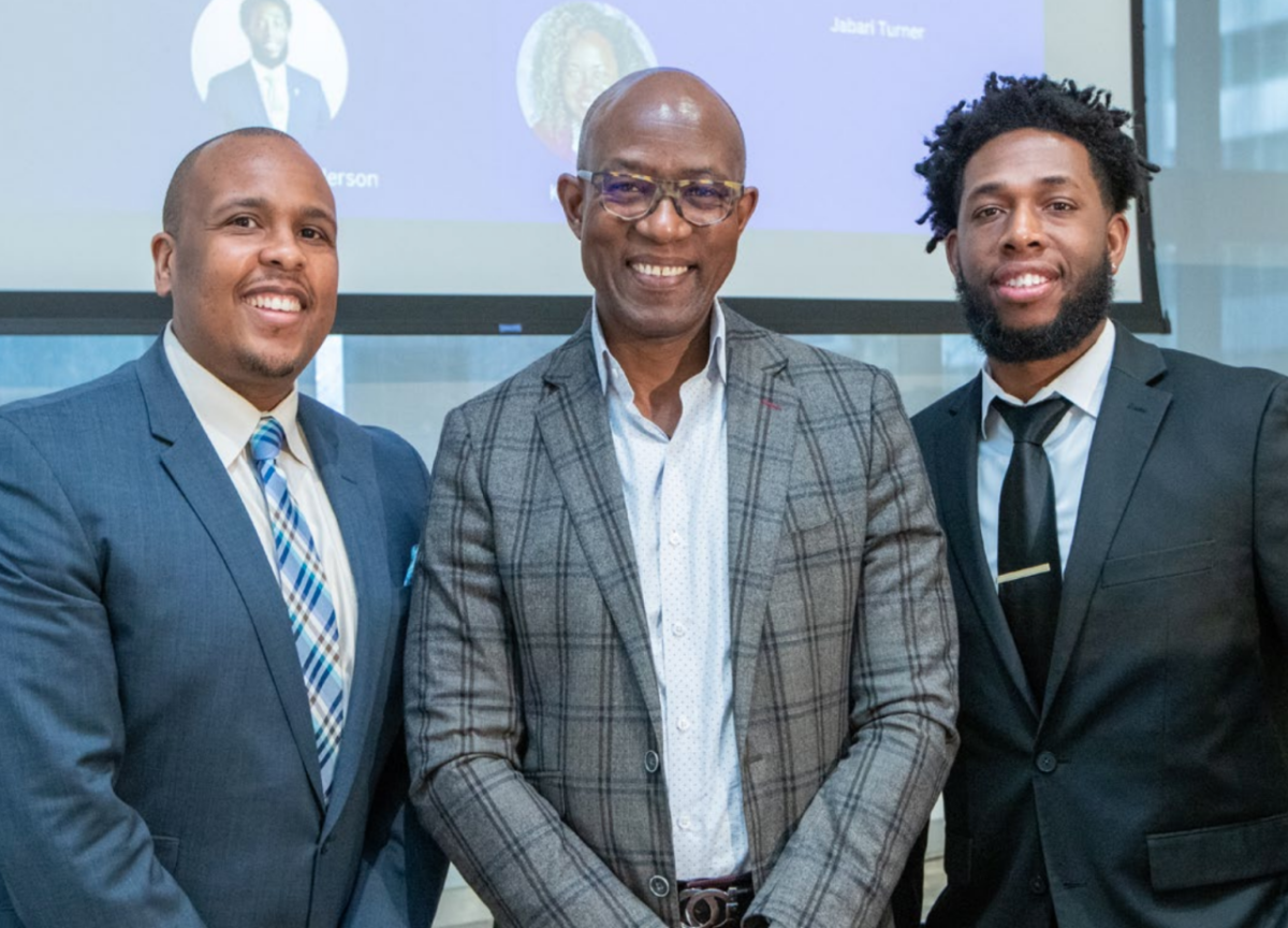 group of three black men in suits smiling