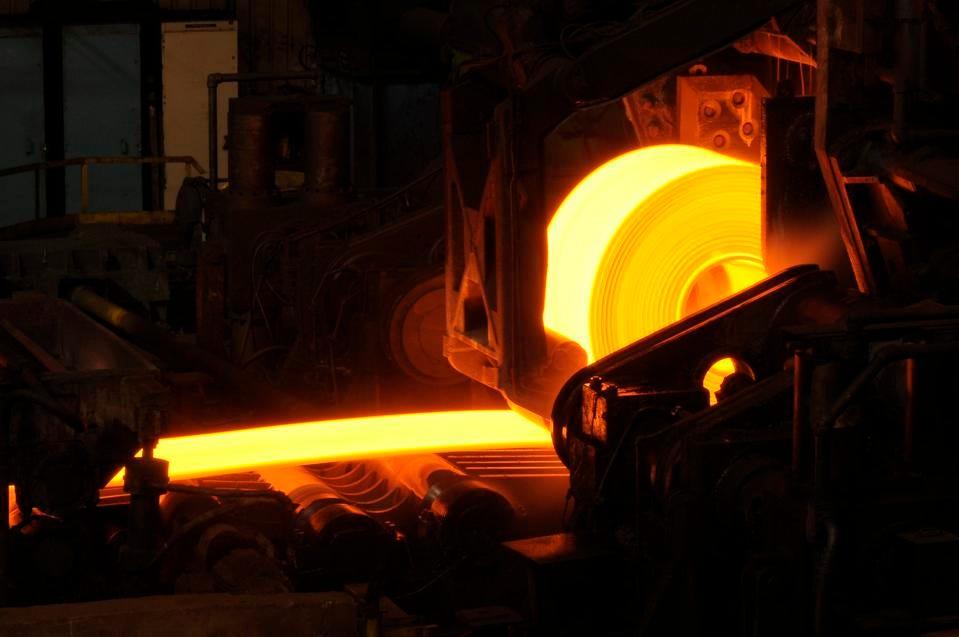 Hot orange steel rolling process in a steel manufacturing industry. Hot rolling is a metalworking process used mainly to produce sheet metal or simple cross sections, such as rail tracks. Image by GETTY courtesy of Forbes.com red hot steel