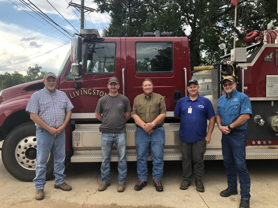 4 Livingston firefighters in front of truck