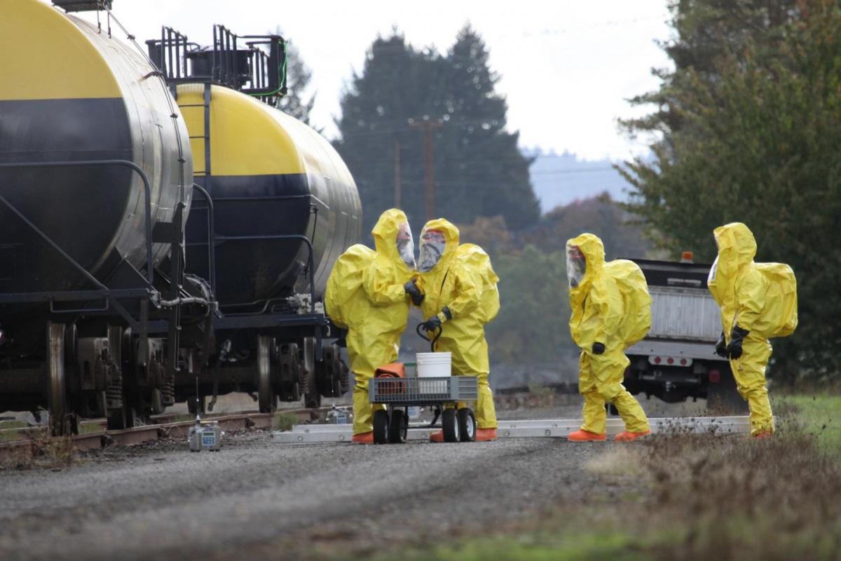 4 emergency responders in full yellow protective suits