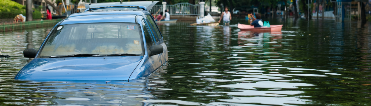 car sinking in a flooded street