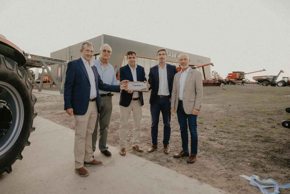 Five people standing together outside a dealership