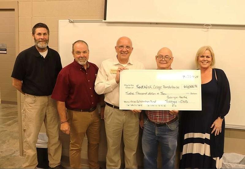 The presentation included Stephen Grayson (left), instructor, South Arkansas College Forestry Technology Program; Craig Sheek, Fordyce OSB plant manager; Ray Winiecki, South Arkansas College dean of Career and Technical Education; Dave Carty, South Arkansas College program director/instructor, Industrial Engineering Technology; and Corina Schindel, Fordyce OSB, HR business partner. (Special to The Commercial) Photo courtesy of The Pine Bluff Commercial. Five people holding an oversized check