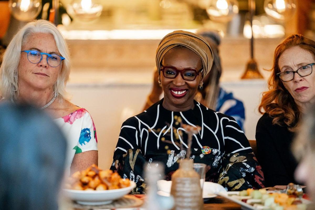 Three people seated at a dining table.