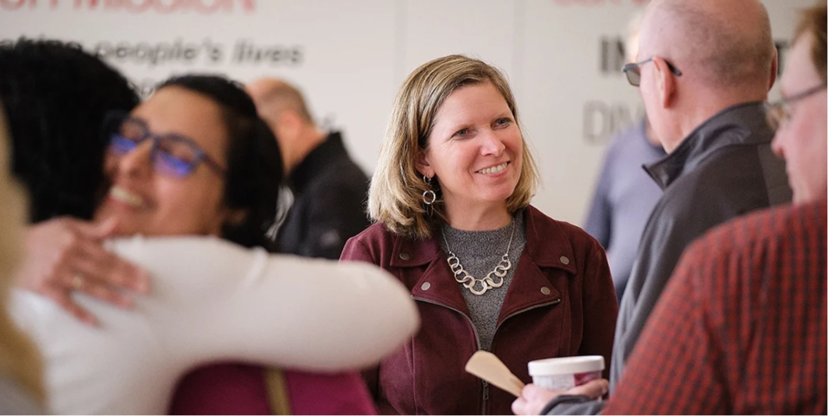 President and Chief Operating Officer Jennifer Rumsey welcomes back Cummins employees to company offices in Columbus, Indiana, earlier this month. people meeting and hugging