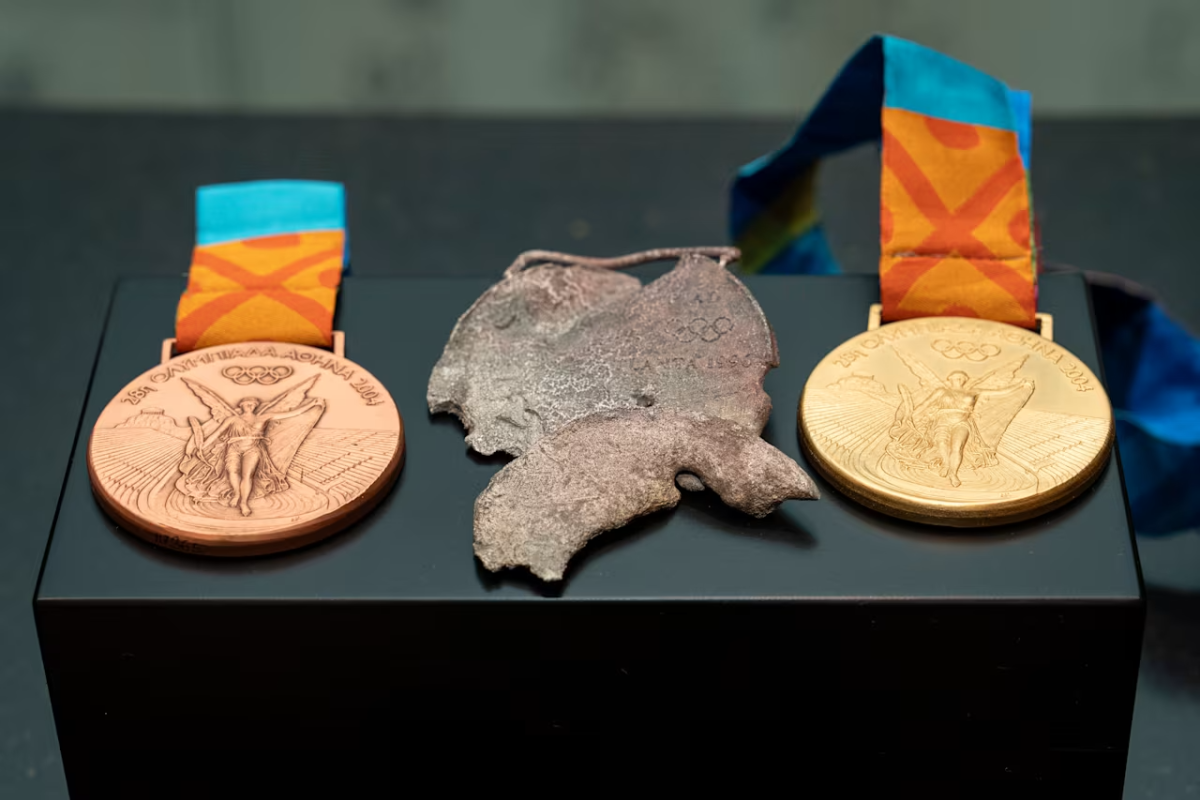 Two new medals on either side of a melted one