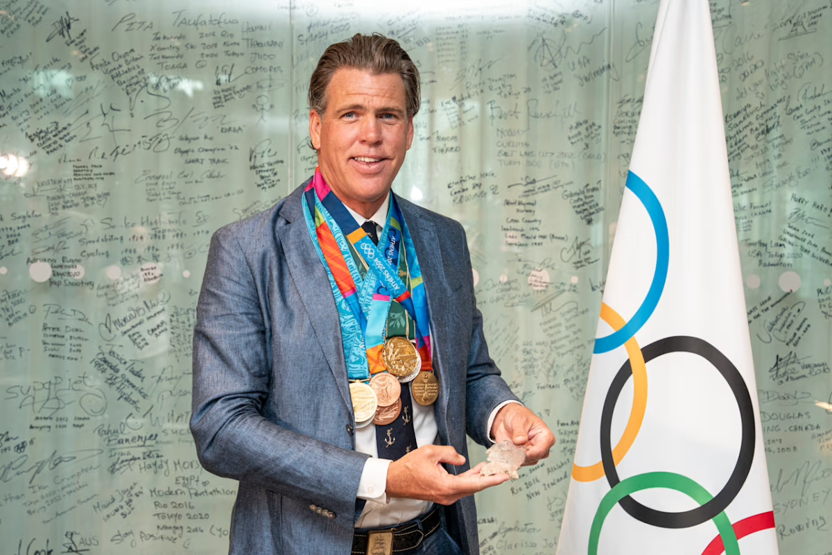 Gary Hall Jr. smiling with many new medals around his neck