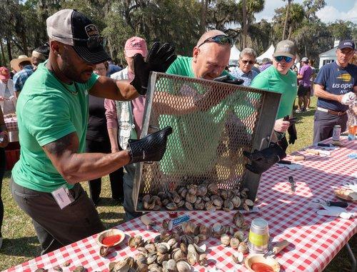 Photo courtesy of The Georgia Conservancy People dropping oysters onto a table