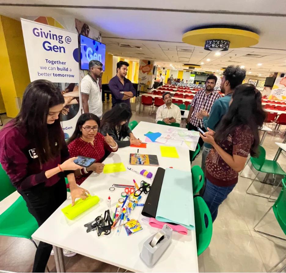 A group of people around a table with crafts and supplies.