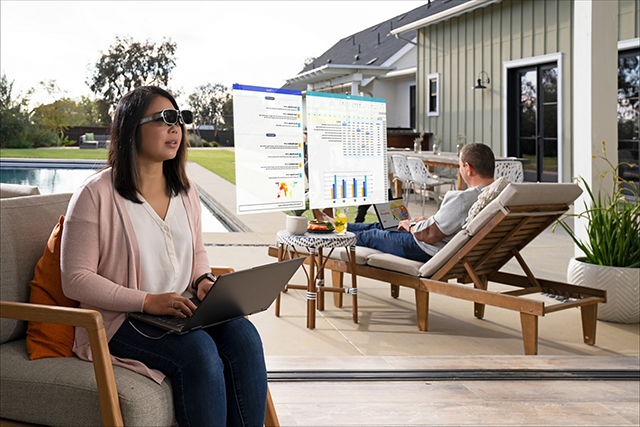 Woman in AR glasses looking at screens