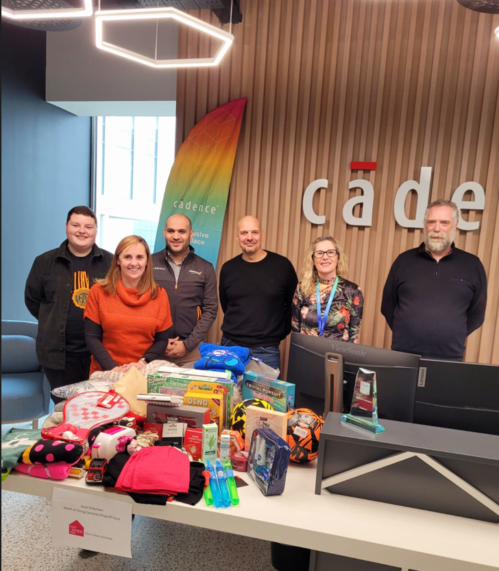 A group of people stood behind a table donation drop off point