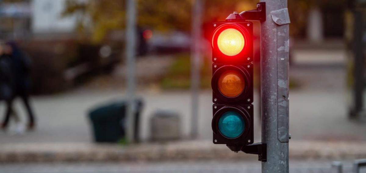 A stoplight shining red.