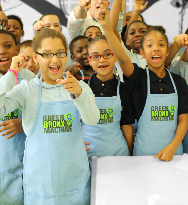 Kids in aprons that read, "Green Bronx Machine"