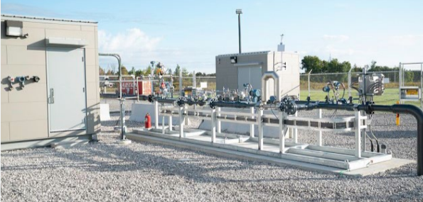 exterior energy building with industrial piping and gravel ground covering