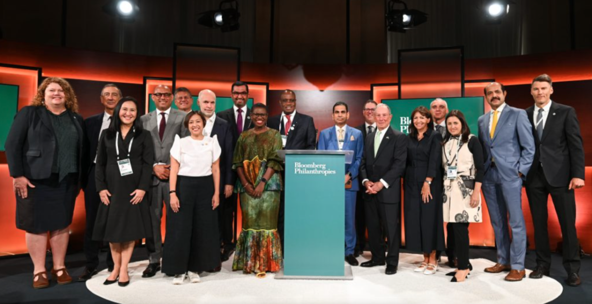 group photo in front of the Bloomberg Philanthropy lectern