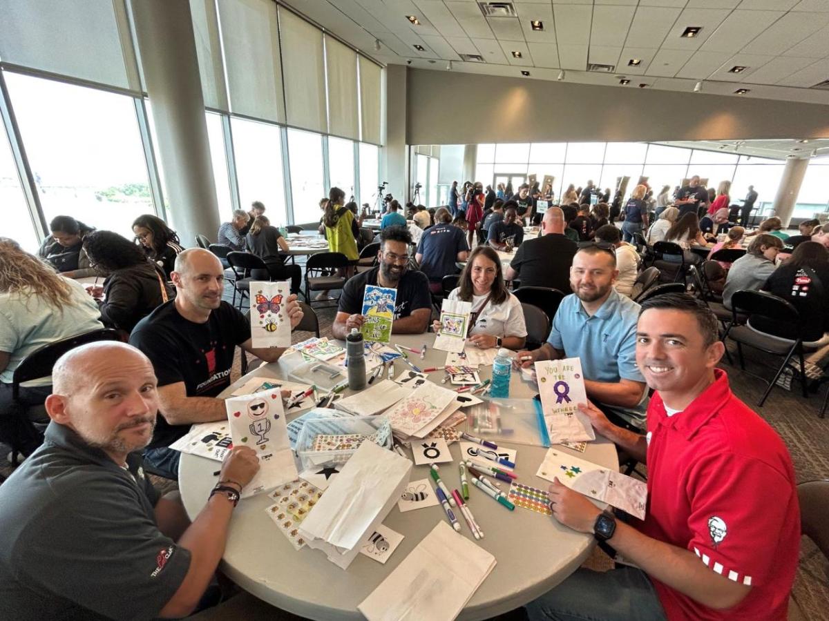 6 volunteers make crafts at a table