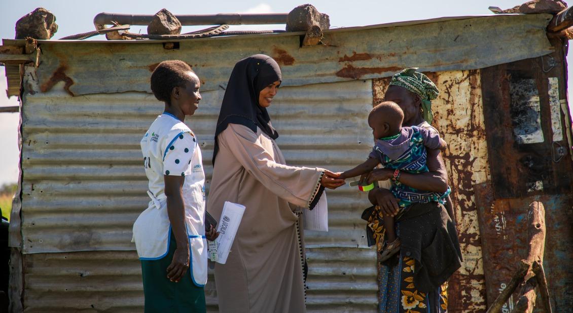 Action Against Hunger health workers greet a grandmother and her grandchild in Kenya. // Photo by Abel Gichuru Action Against Hunger health workers greet a grandmother and her grandchild in Kenya. // Photo by Abel Gichuru