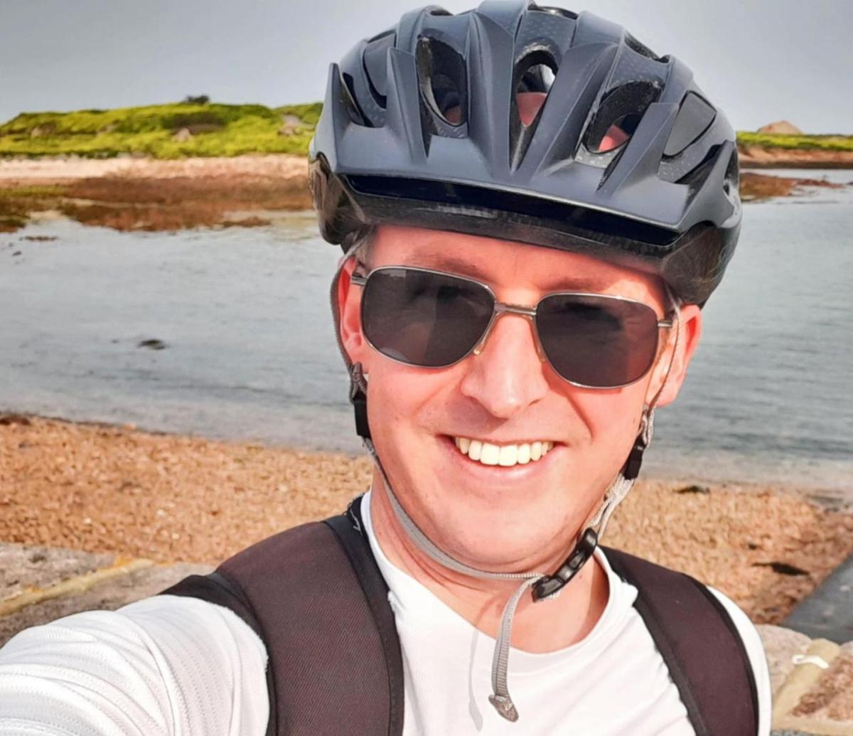 A person in a bike helmet and sunglasses