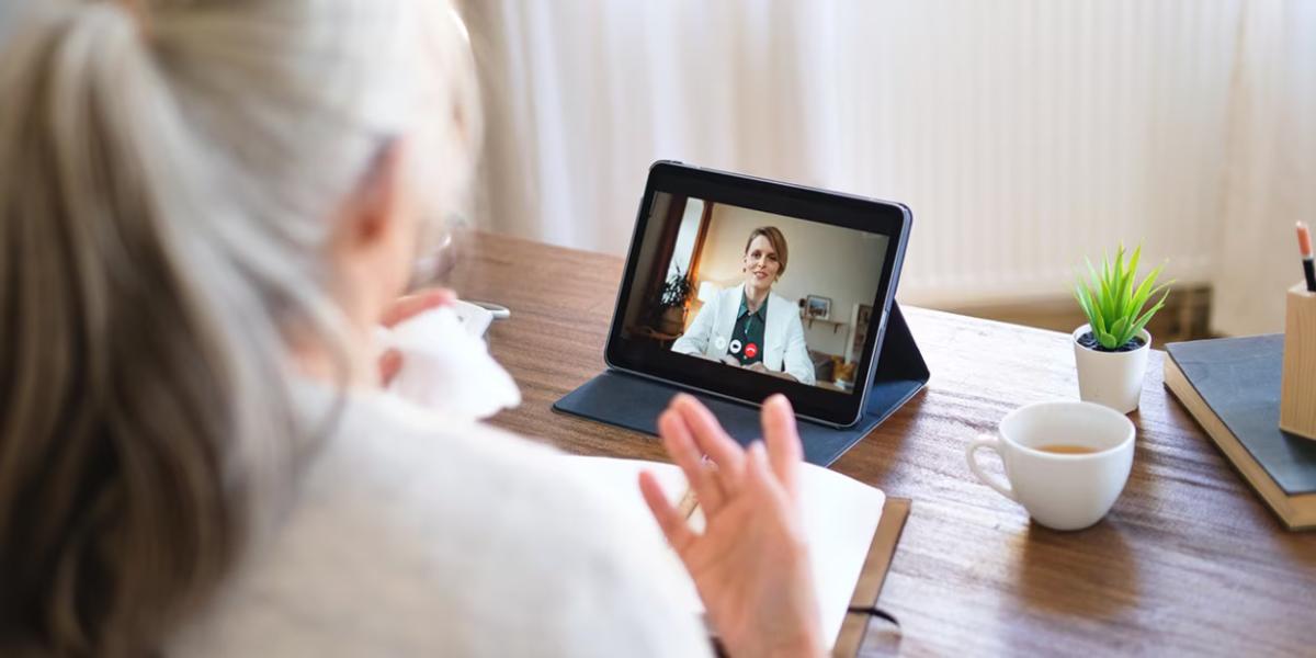 A person having a video call on a tablet device