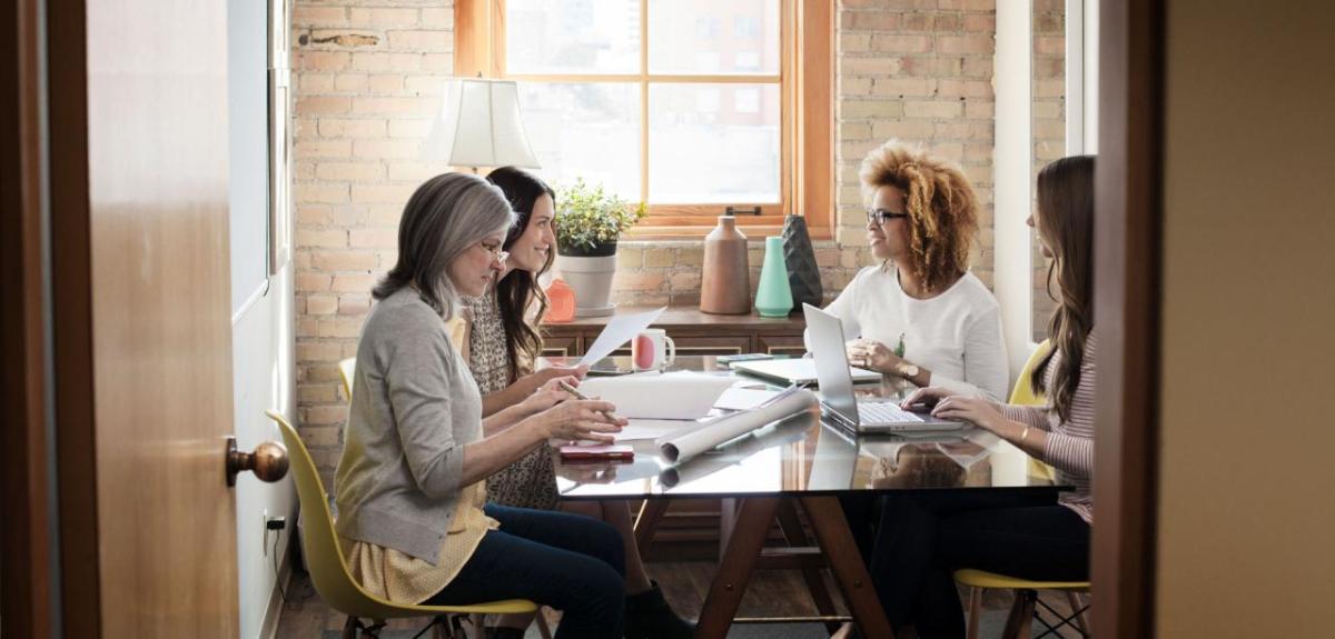 4 people sitting at a meeting