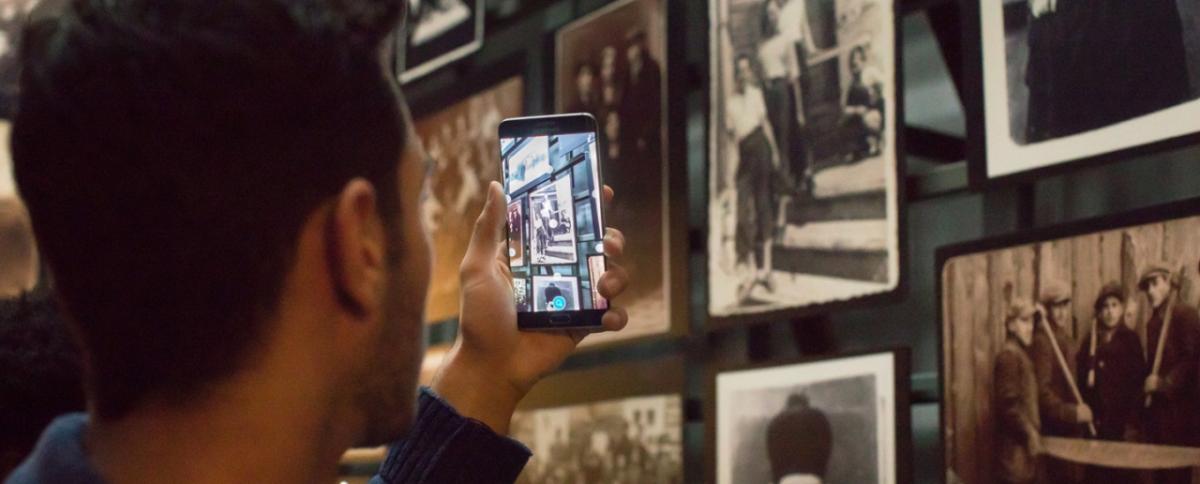 A student tests out the United States Holocaust Memorial Museum’s augmented reality experience in the “Tower of Faces” section of the main exhibition.
