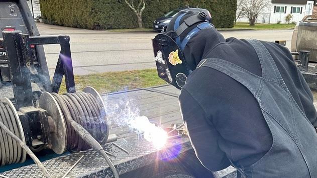 A student at Hope Secondary School in Hope, BC uses a portable welding unit donated by Enbridge. " "