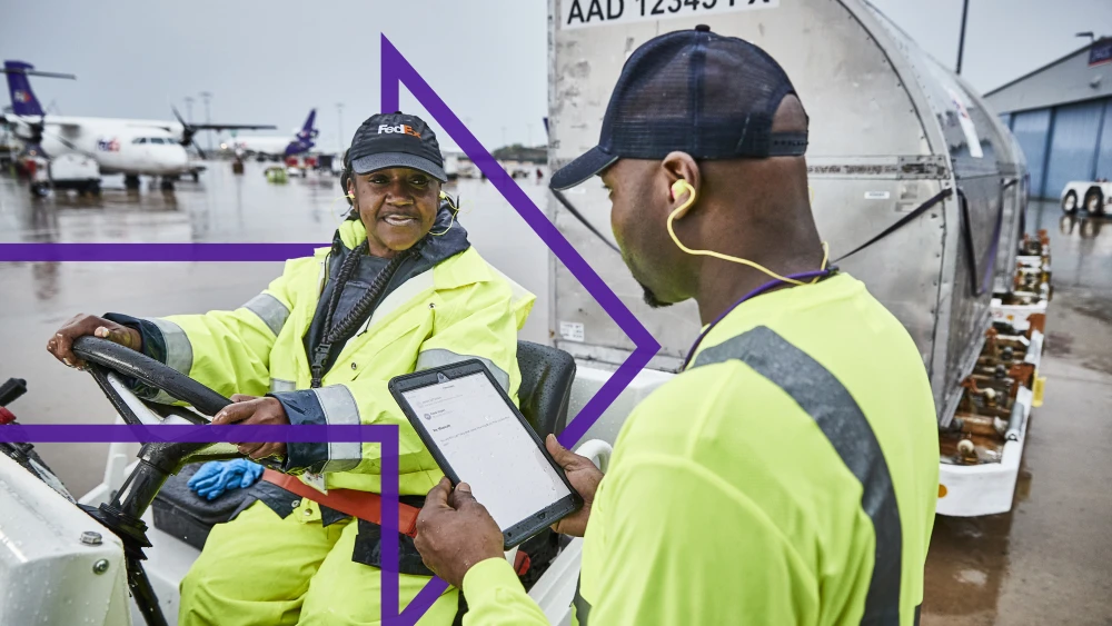 Two FedEx employees at work