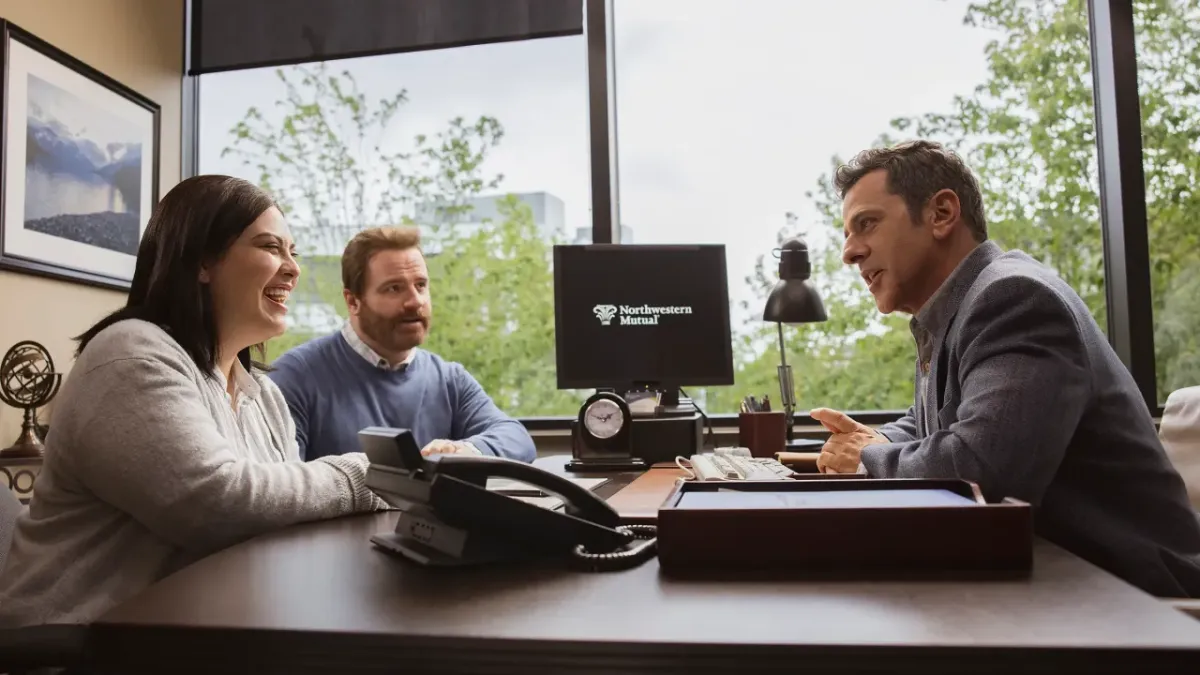an advisor speaking with two clients