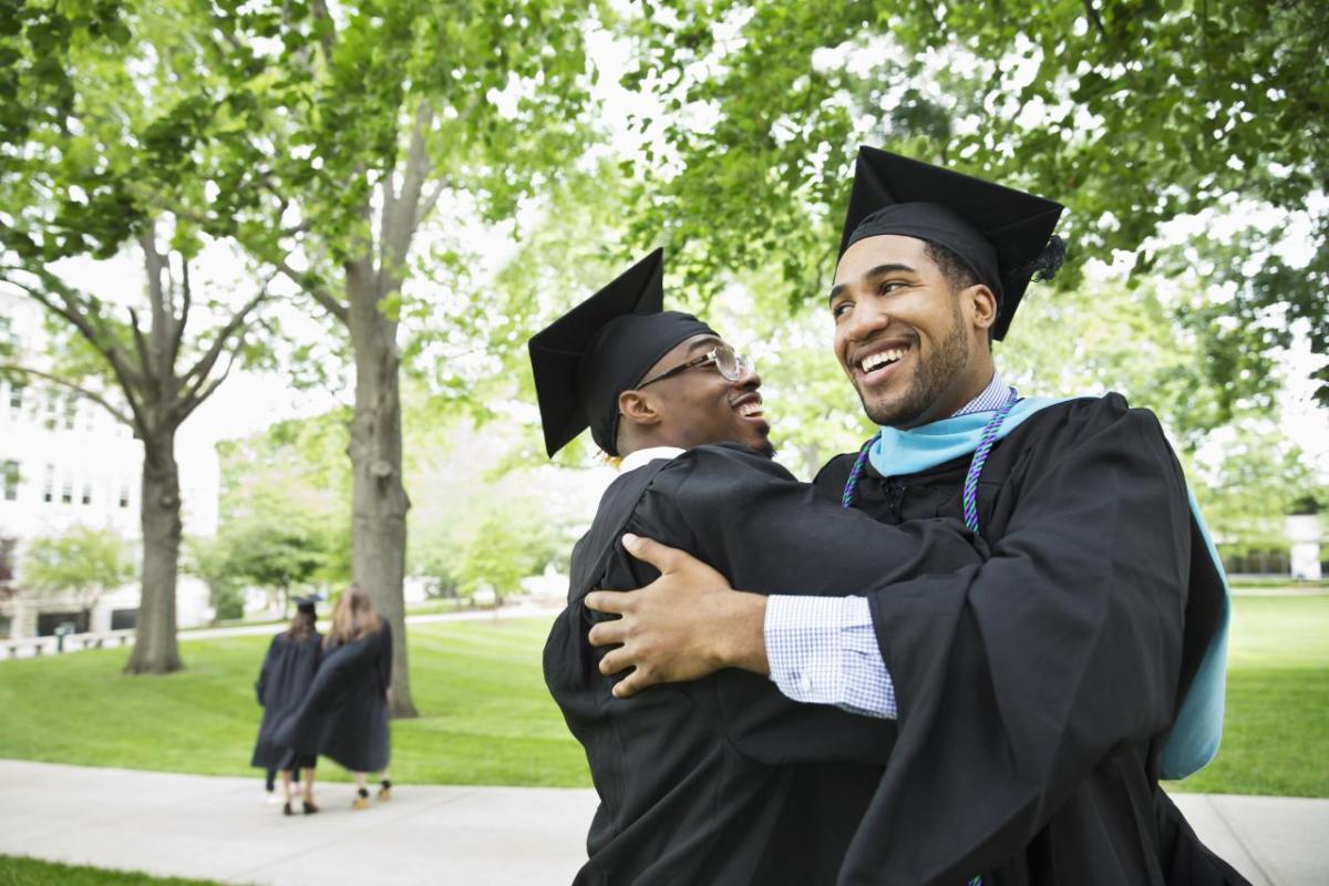 graduates hugging