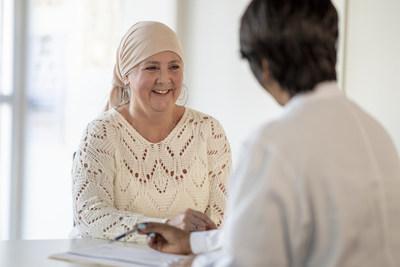 Female cancer patient consulting with a doctor. Patient is wearing a headscarf.