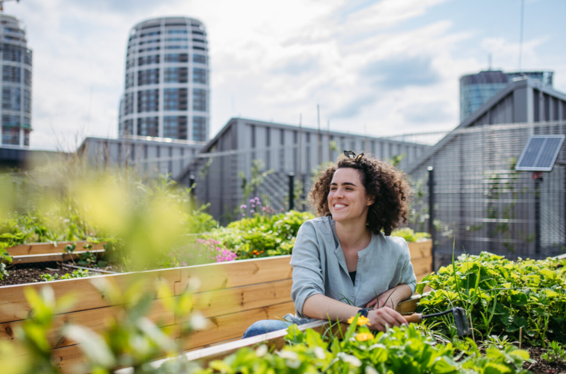 Medtronic 2024 Impact Report Woman smiling next to a garden bed