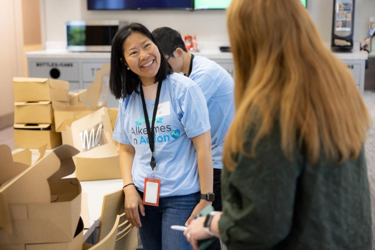 Volunteers smiling by open boxes.