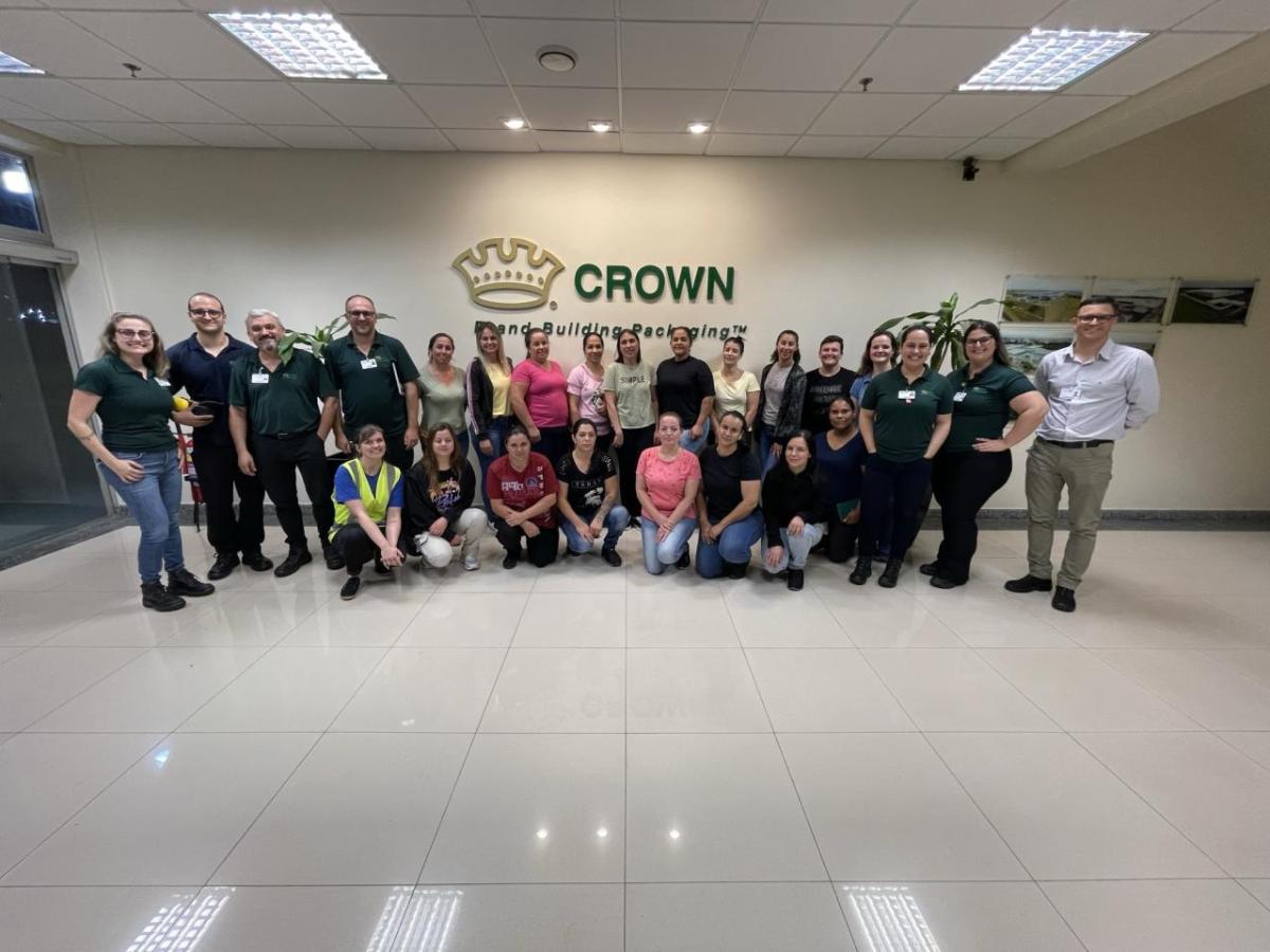 A group posed in an entryway. "Crown" sign on the wall behind them.