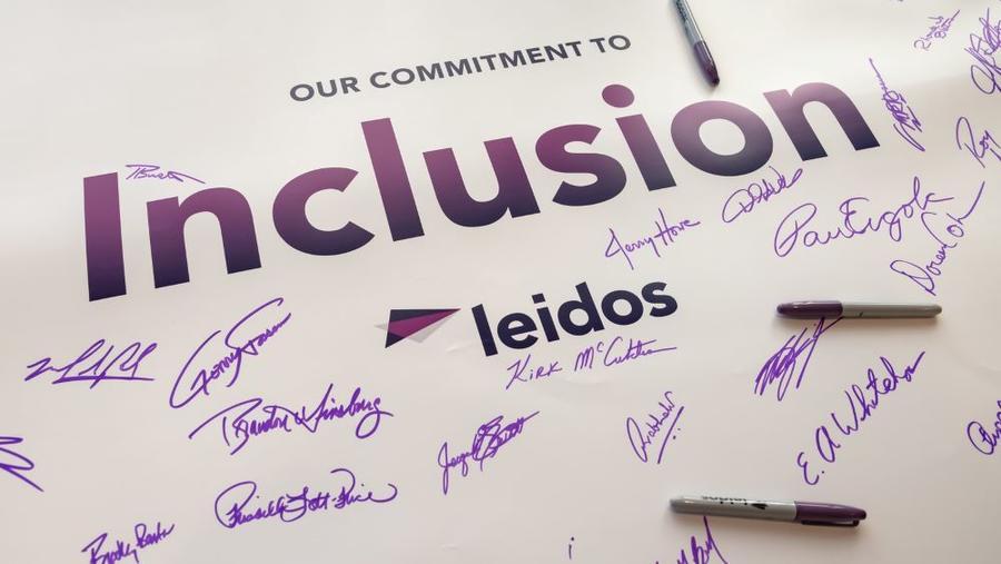 Photo: Jay Townsend Signed poster that reads " Our Commitment to Inclusion, Leidos"