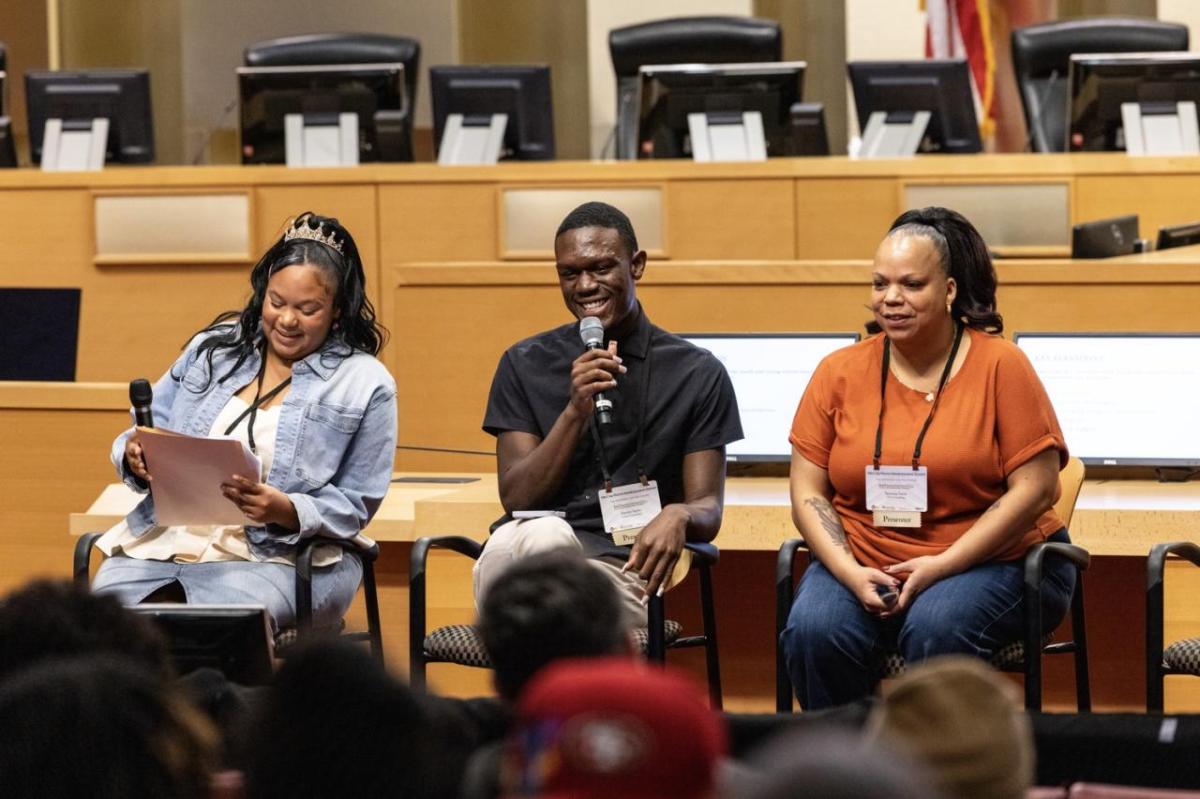 Three people presenting to a group